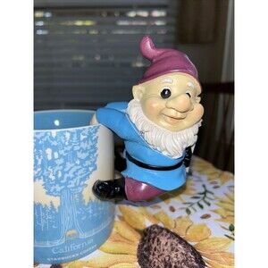 gnome statue hangs on pot